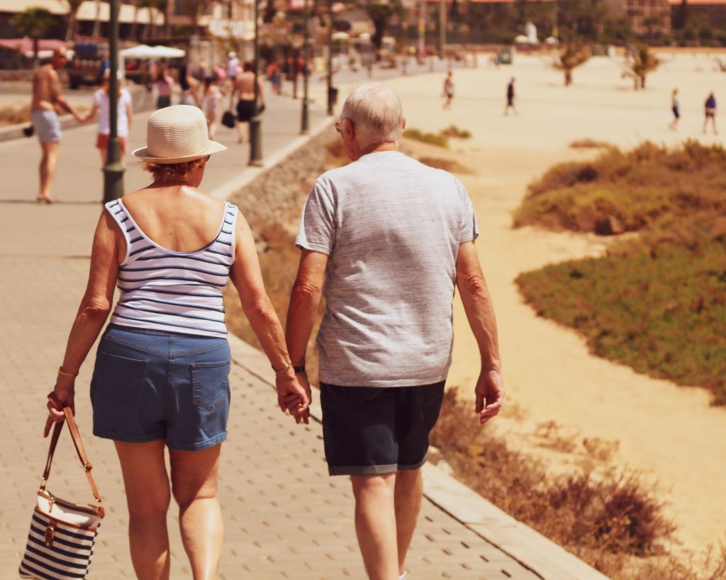 man and woman walking on promenade