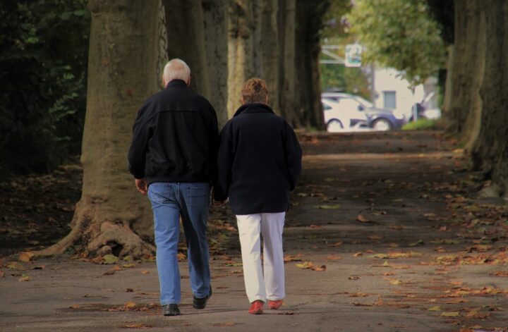 man and woman walking in autumn